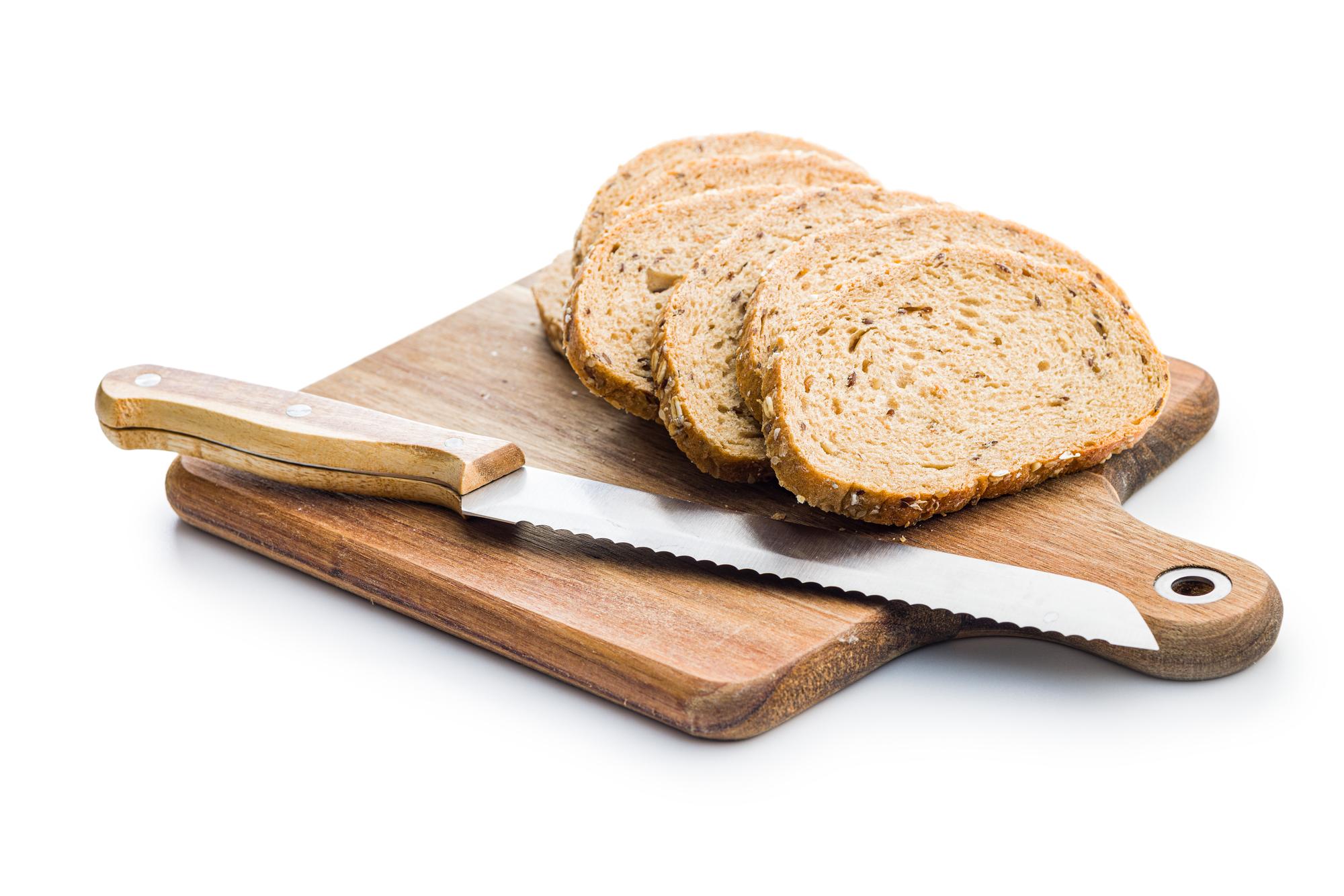 Sliced loaf and butter on a board
